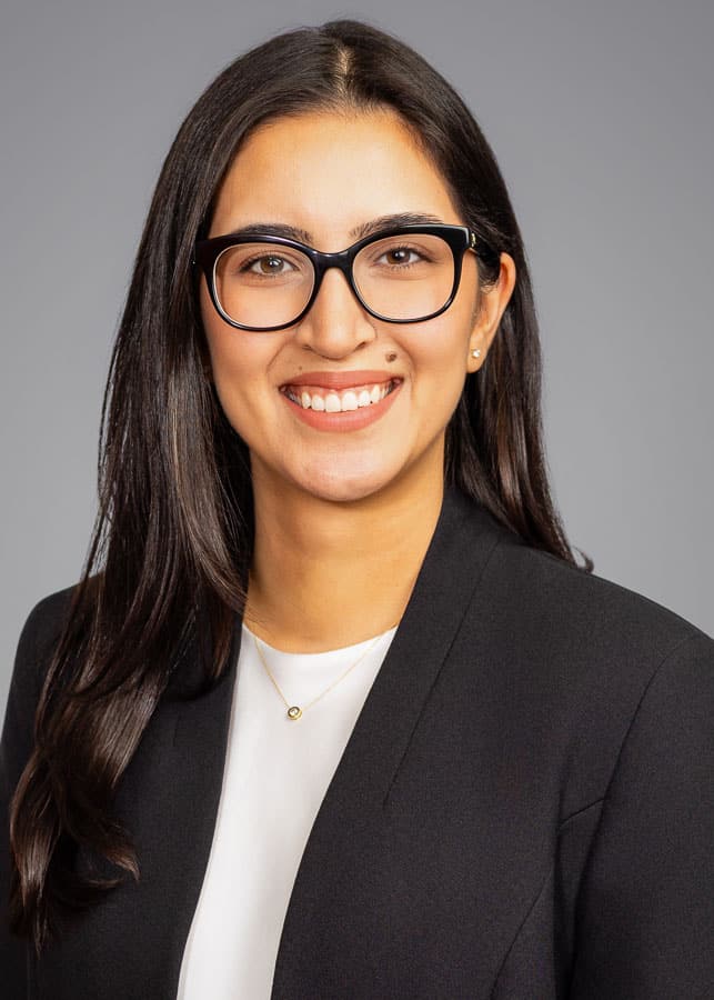 St. Louis businesswoman in professional headshot session smiling confidently in natural light studio